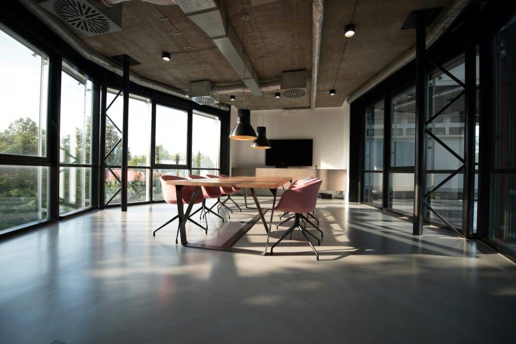 Modern meeting room with a long table and large windows