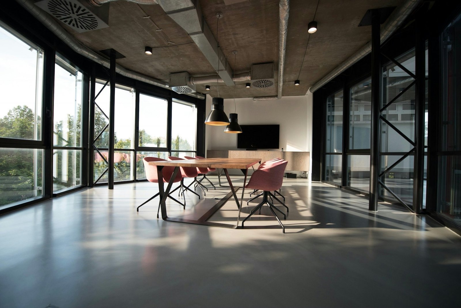 Modern meeting room with a long table and large windows