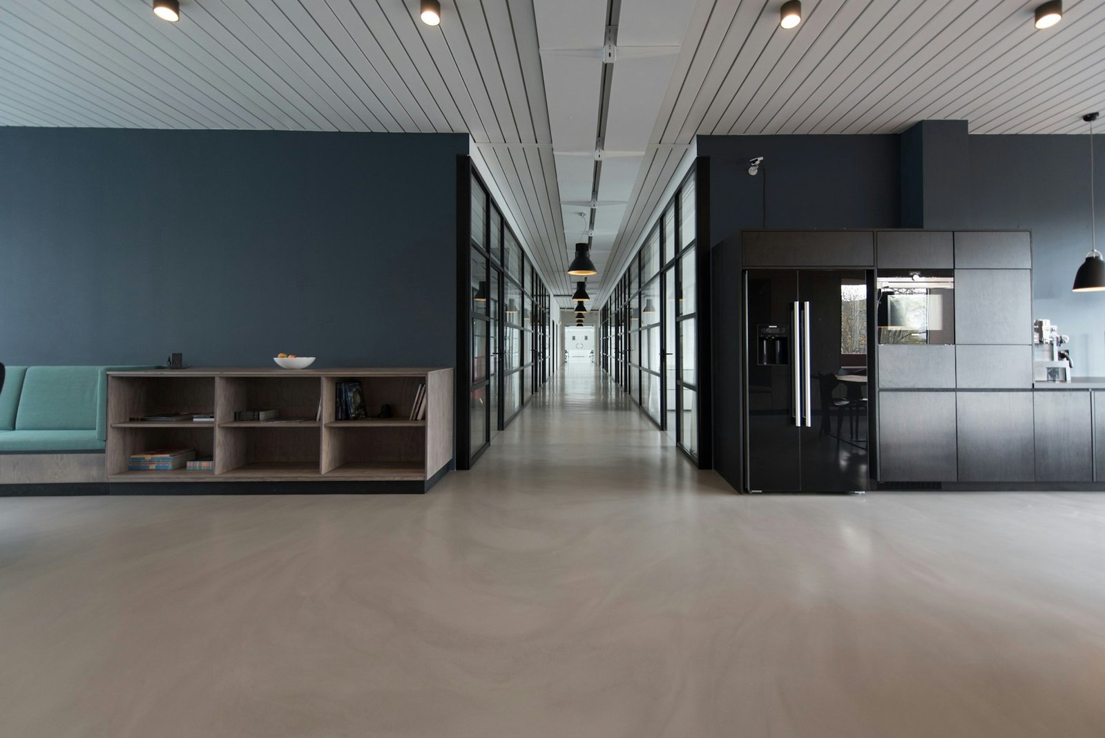 Modern open-plan office with glass-walled meeting rooms
