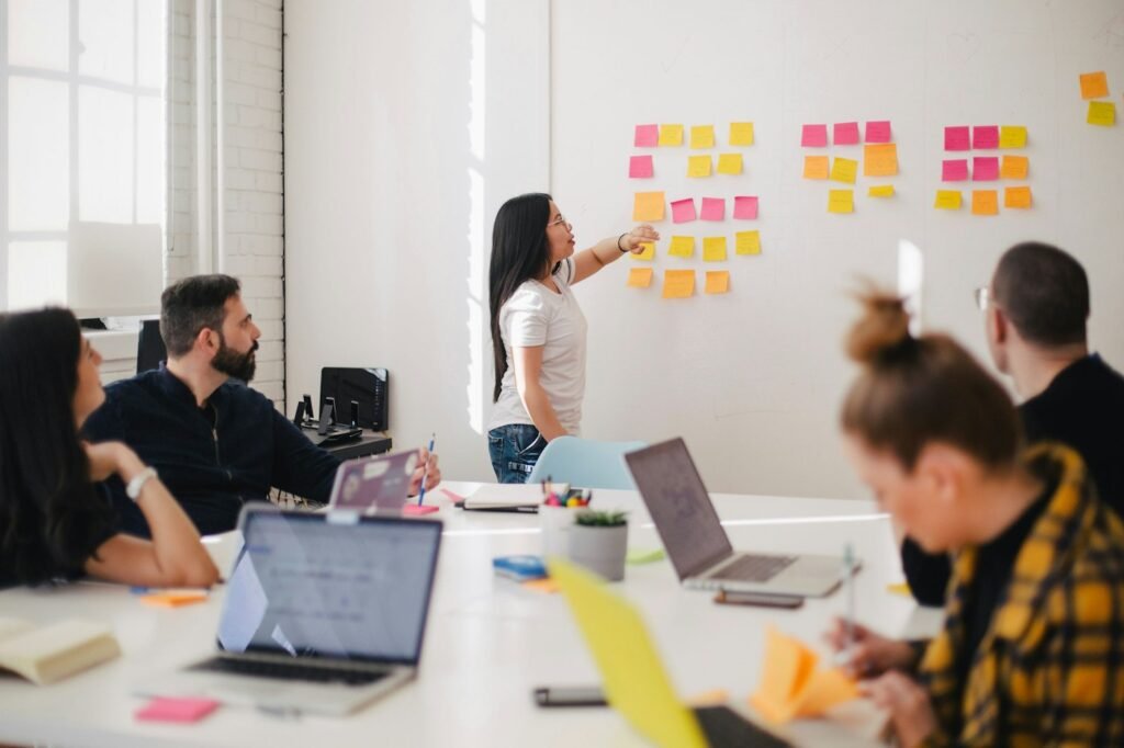 Team brainstorming with sticky notes on a whiteboard