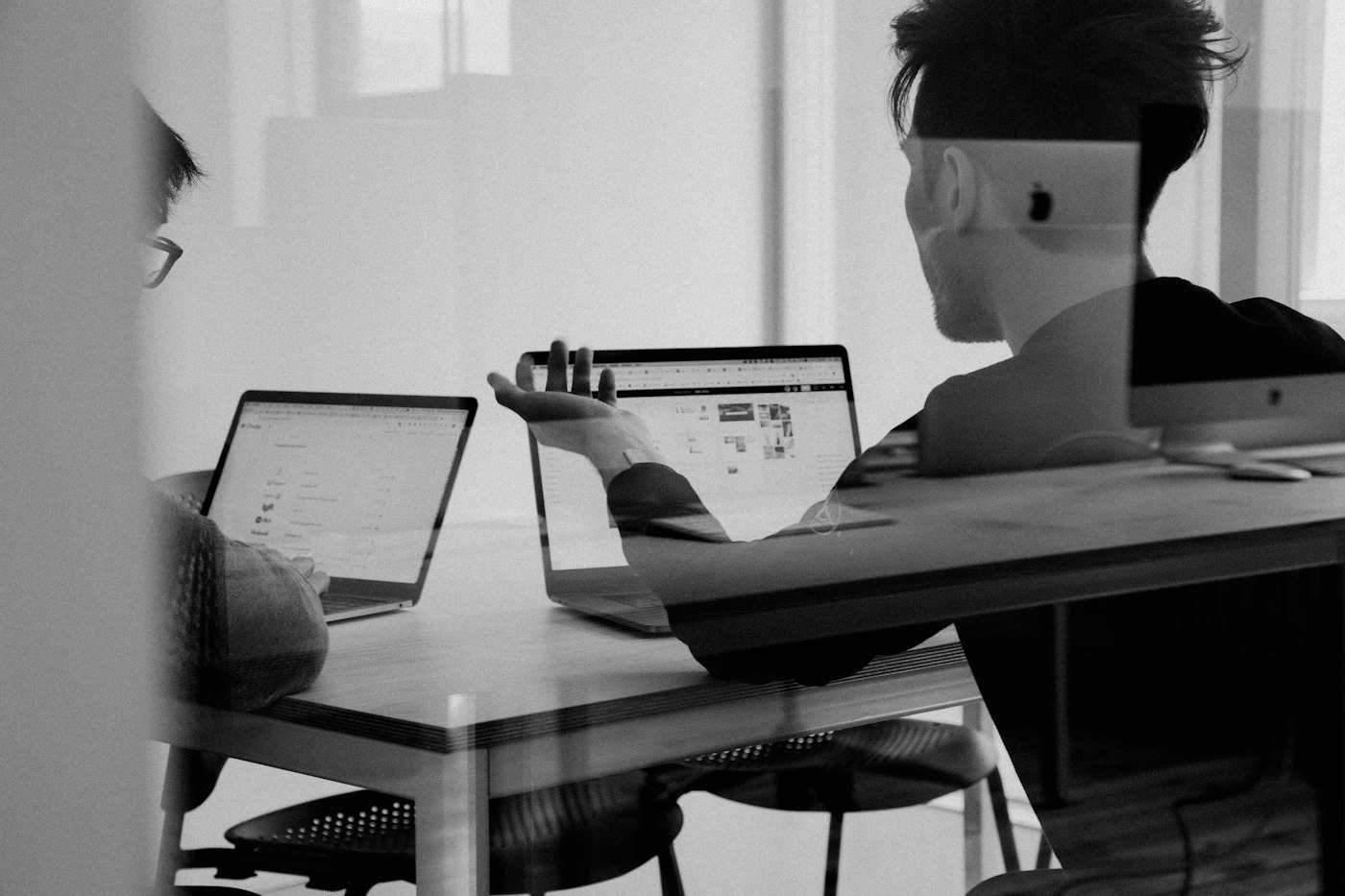 Colleagues working at laptops in a modern office